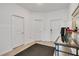Inviting foyer featuring three interior doors, wood-look tile flooring, and a console table at 109 Pineywoods St, St Cloud, FL 34772