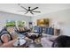 Bright living room with modern furnishings, large windows, ceiling fan, and stylish decor at 109 Pineywoods St, St Cloud, FL 34772