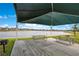 Community picnic area with lake view, featuring multiple picnic tables and a grill at 109 Pineywoods St, St Cloud, FL 34772