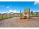 Community playground with a playhouse structure surrounded by a mulch ground at 109 Pineywoods St, St Cloud, FL 34772