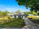 Charming single-story home with a green lawn, classic siding, and a well-manicured landscape on a sunny day at 1401 Nw 63Rd Pl, Ocala, FL 34475