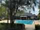 Community pool area with lounge chairs, a large pool, and lush landscaping at 2991 Saint Clair St, Kissimmee, FL 34746
