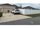 Exterior of the home with a paved driveway, fenced yard, and a white SUV parked at 2991 Saint Clair St, Kissimmee, FL 34746