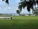 Scenic lake view with a bench, grassy area, and a wooden dock extending into the water at 2991 Saint Clair St, Kissimmee, FL 34746