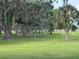 Community park featuring mature trees, picnic tables, and playground equipment, offering a serene outdoor space at 2991 Saint Clair St, Kissimmee, FL 34746