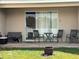 Covered outdoor patio area with sliding glass doors, seating, and partial lawn view at 2991 Saint Clair St, Kissimmee, FL 34746