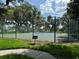 Well-maintained community tennis court, perfect for recreational play, surrounded by lush landscaping and secure fencing at 2991 Saint Clair St, Kissimmee, FL 34746