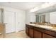 Bathroom featuring a double vanity, granite counters, and walk-in shower at 3341 Rodrick Cir, Orlando, FL 32824