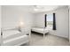 Bright bedroom with two twin beds, white furniture, and a view of the outdoors at 3341 Rodrick Cir, Orlando, FL 32824