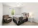 Cozy bedroom with neutral decor, featuring a comfortable chair and bright window at 3341 Rodrick Cir, Orlando, FL 32824