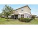 Two-story home featuring a screened lanai and landscaped yard with mature trees and green hedges at 3341 Rodrick Cir, Orlando, FL 32824