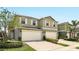 Two-story home featuring a two-car garage, neutral paint, complemented by well-maintained landscaping and bright natural light at 3341 Rodrick Cir, Orlando, FL 32824