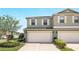 Two-story home featuring a two-car garage, neutral paint, complemented by well-maintained landscaping and bright natural light at 3341 Rodrick Cir, Orlando, FL 32824