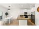 Modern kitchen featuring an island, stainless steel appliances, white cabinets, and an adjacent dining area at 3341 Rodrick Cir, Orlando, FL 32824