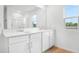 A bright bathroom featuring dual sinks and a large mirror for enhanced functionality at 1743 Carnelian St, Deland, FL 32720