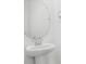 Clean bathroom featuring a pedestal sink and a round frameless mirror at 1743 Carnelian St, Deland, FL 32720