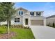 Charming two-story home with neutral colors, a two-car garage, and fresh landscaping at 1743 Carnelian St, Deland, FL 32720