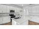 Bright kitchen featuring white cabinets, stainless steel appliances, quartz countertops and a large kitchen island at 1743 Carnelian St, Deland, FL 32720