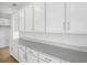 Expansive kitchen with white cabinets, quartz countertops, stainless steel hardware and modern appliances at 1743 Carnelian St, Deland, FL 32720