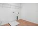 Bright laundry room with white walls, wood-look tile flooring, and practical shelving at 1743 Carnelian St, Deland, FL 32720