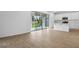 Open concept living space with wood-look floors and glass sliding doors to lanai at 1743 Carnelian St, Deland, FL 32720
