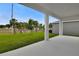 Covered patio with white columns overlooking the grassy yard and serene community landscape at 1743 Carnelian St, Deland, FL 32720