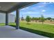 Covered back porch with a view of the expansive backyard and blue skies at 1745 Carnelian St, Deland, FL 32720