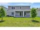 Well-maintained backyard featuring a covered patio and sliding glass doors, perfect for outdoor entertaining at 1745 Carnelian St, Deland, FL 32720