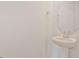 Clean powder room featuring a pedestal sink and a circular mirror at 1745 Carnelian St, Deland, FL 32720