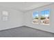 Bright bedroom featuring a carpet floor and two windows with neighborhood views at 1745 Carnelian St, Deland, FL 32720