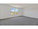 Well-lit bedroom featuring a carpet floor and a window with a view at 1745 Carnelian St, Deland, FL 32720