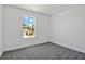 Well-lit bedroom featuring a carpet floor and a window overlooking the yard at 1745 Carnelian St, Deland, FL 32720
