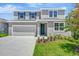 Charming two-story home with a well-maintained lawn, lovely landscaping, and a two car garage at 1745 Carnelian St, Deland, FL 32720