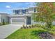 Charming two-story home with a well-maintained lawn, lovely landscaping, and a two car garage at 1745 Carnelian St, Deland, FL 32720