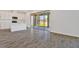 Open-concept living space with tiled floors, white walls, and a view to the covered patio at 1745 Carnelian St, Deland, FL 32720