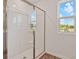 Bathroom showcasing a glass-enclosed shower and a window offering natural light at 1745 Carnelian St, Deland, FL 32720