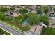 Aerial view showcases community tennis courts, mature trees, and neighborhood streets at 3852 Brantley Place Cir, Apopka, FL 32703
