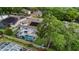 Aerial shot of a home with solar panels, a screened-in pool, and a well-manicured backyard at 3852 Brantley Place Cir, Apopka, FL 32703