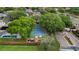 Aerial view of tennis court, playground, pool, and gated entrance at 3852 Brantley Place Cir, Apopka, FL 32703