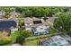 Aerial view of a home with a backyard pool, screened enclosure, and solar panels at 3852 Brantley Place Cir, Apopka, FL 32703