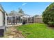 Well-maintained backyard with lush green grass, a screened patio and a view of the pool at 3852 Brantley Place Cir, Apopka, FL 32703