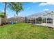 Backyard featuring a screened in pool, green grass, a tree, and outdoor furniture at 3852 Brantley Place Cir, Apopka, FL 32703