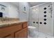 Well-lit bathroom with a granite countertop, decorative shower tiles, and a modern glass door at 3852 Brantley Place Cir, Apopka, FL 32703