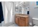 Bathroom with a granite countertop, wood cabinets, and a view to the outside patio at 3852 Brantley Place Cir, Apopka, FL 32703