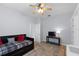Comfortable bedroom with a black daybed, ceiling fan, and wooden desk at 3852 Brantley Place Cir, Apopka, FL 32703