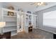 Inviting bedroom features built-in bookshelves, a desk area, and an ensuite bathroom at 3852 Brantley Place Cir, Apopka, FL 32703