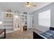 Bedroom with a ceiling fan, built-in shelves, a desk, and access to a bathroom at 3852 Brantley Place Cir, Apopka, FL 32703