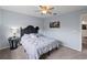 Bedroom with a full-sized bed, gray linen, carpeted floors, and a dark wood side table at 3852 Brantley Place Cir, Apopka, FL 32703