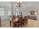 Elegant dining room with a large wooden table, ornate chairs, and stylish decor, perfect for hosting gatherings at 3852 Brantley Place Cir, Apopka, FL 32703