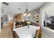 A dining room features a chandelier, flowers, and an open floor plan that connects to the kitchen and living room at 3852 Brantley Place Cir, Apopka, FL 32703